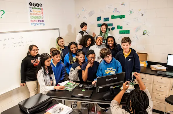 A group of Code Club members poses for a photo.