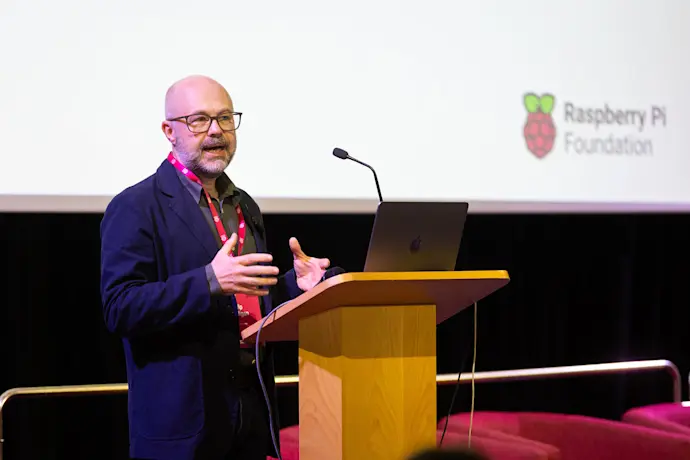 Raspberry Pi Foundation CEO Philip Colligan speaks at a lectern on stage.