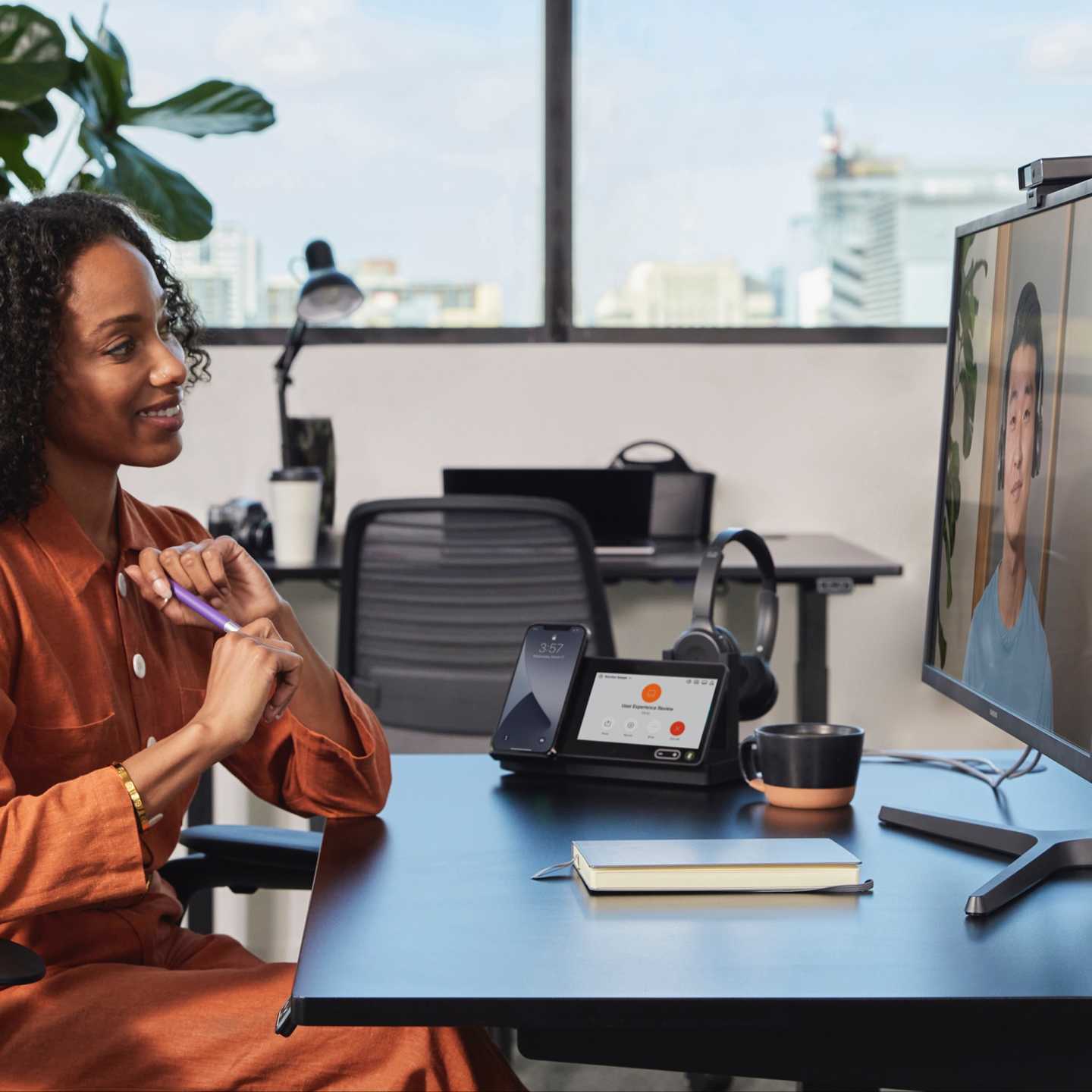 A woman using The Webex Desk Hub device in a video meeting