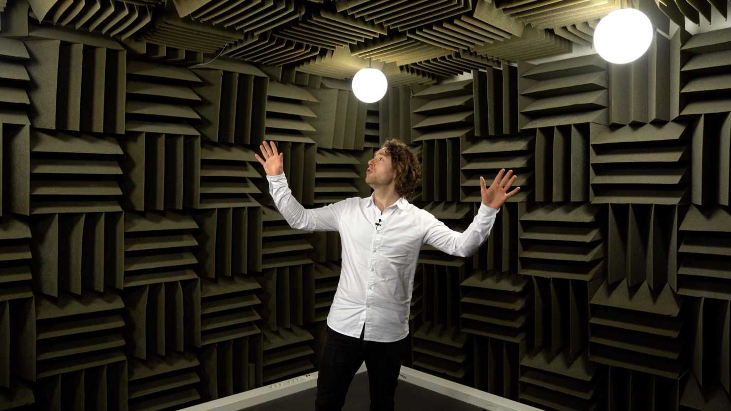 Man standing in a room with acoustic material on walls and ceiling