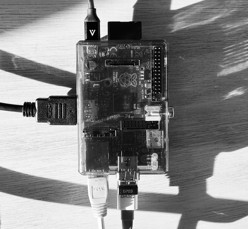 A top-down image of a Raspberry Pi computer with all of the wires plugged into the ports