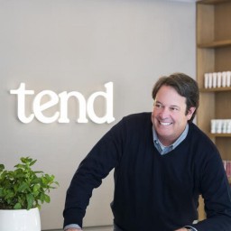Doug Hudson, Tend CEO, with Tend sign behind him