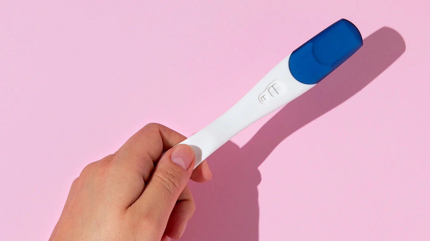 image top-view-hand-holding-pregnancy-test
