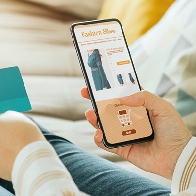 Person purchasing clothes with a credit card on a smartphone