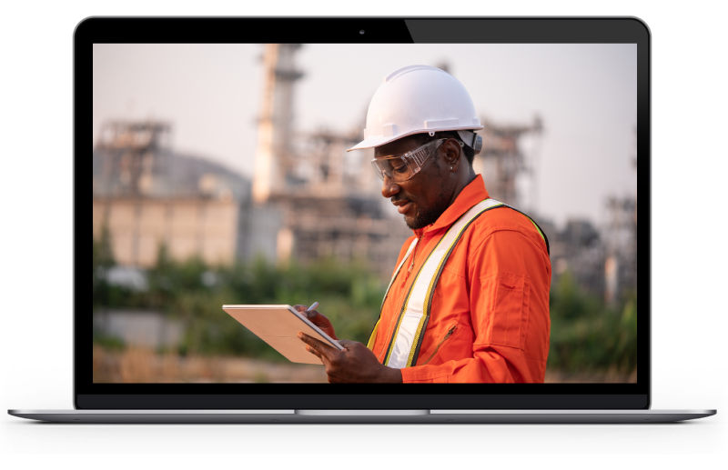 Oil and gas employee reviewing work plan video on a laptop