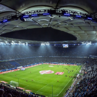 A live sporting event is being held inside a stadium with fans