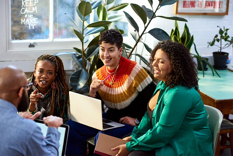 Company employees are collaborating in a team meeting