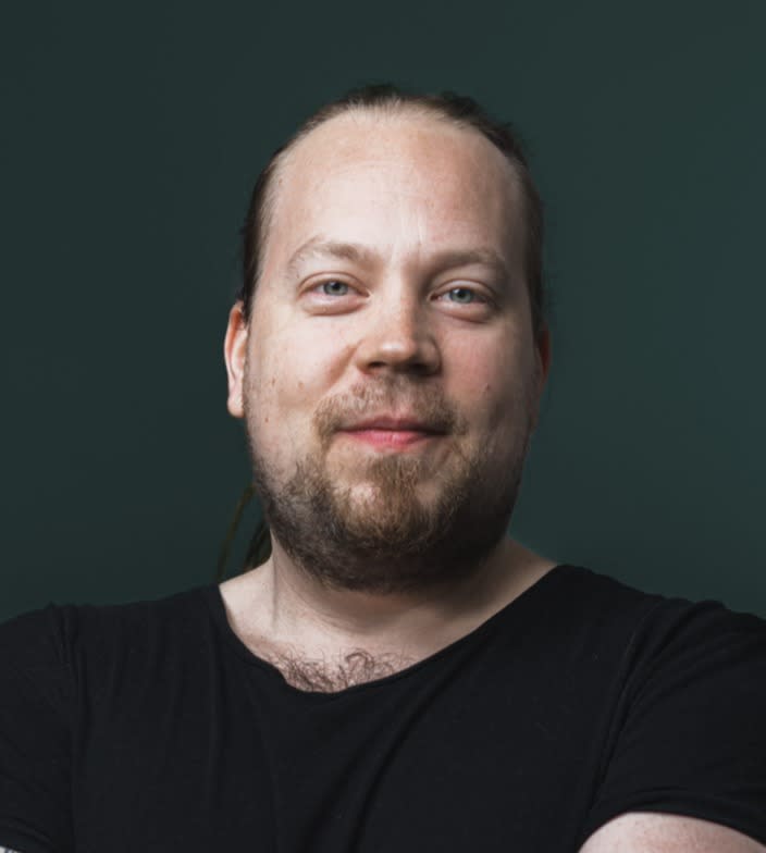 Portrait of a smiling man wearing a black t-shirt