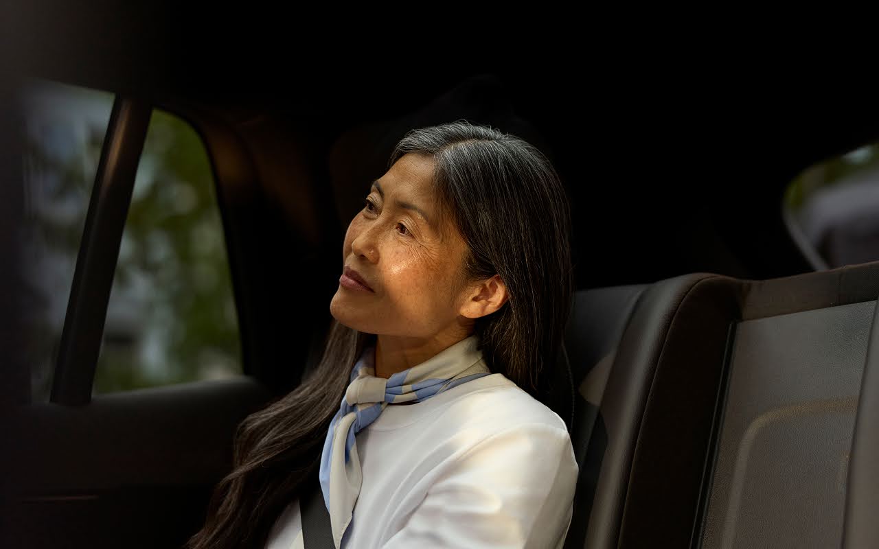 A car service passenger relaxes in the luxurious backseat of a Blacklane limo.