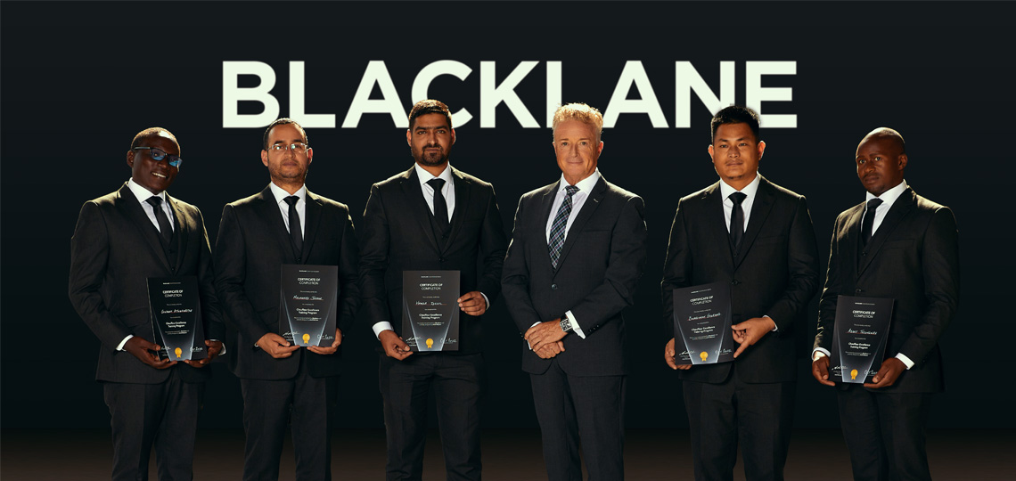 Five graduates of the Blacklane Chauffeur Academy hold their certificates, with their teacher in the middle.
