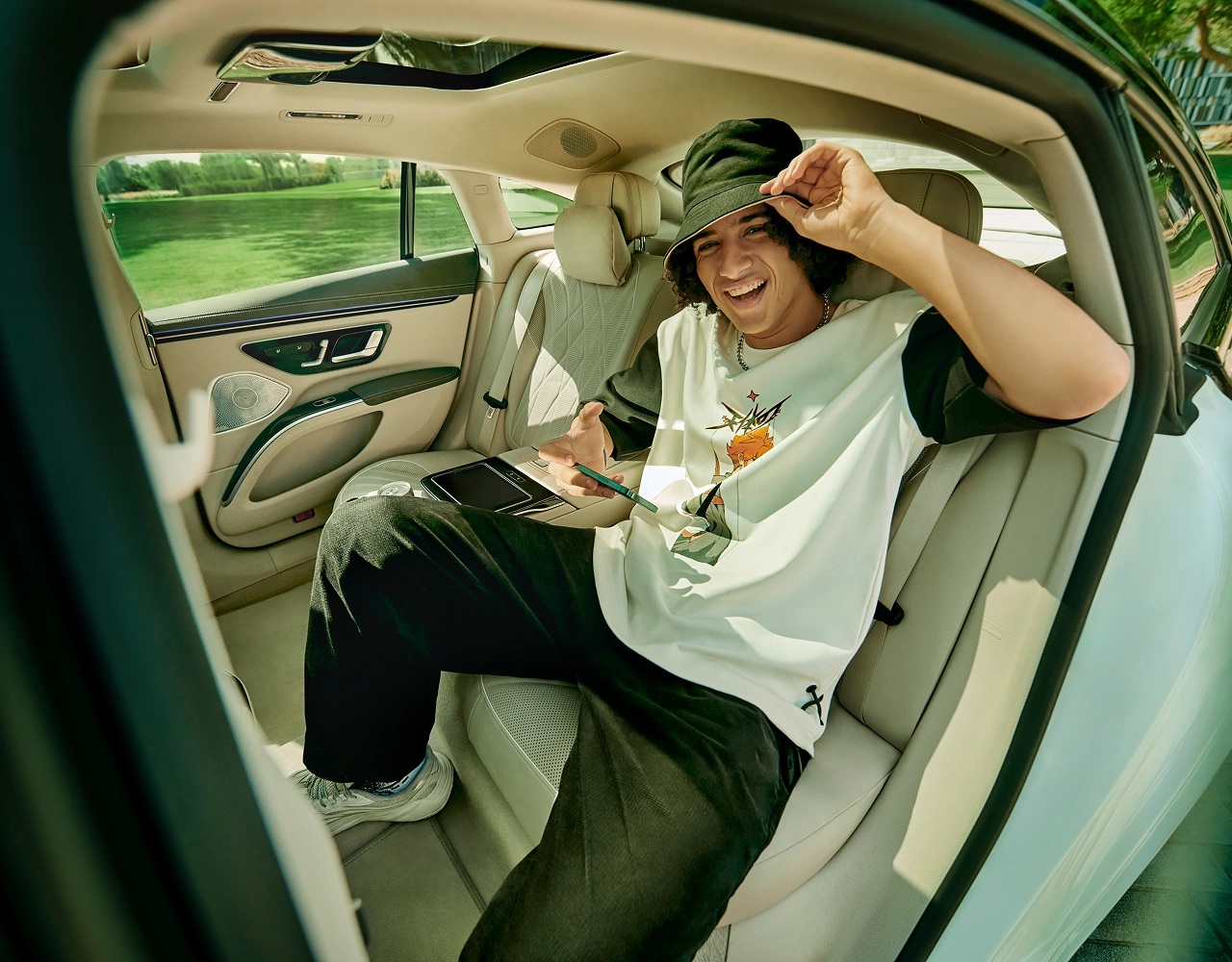 A sports fan sits in the back of a Blacklane limo.