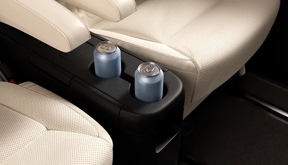 Interior shot of two cans of water in between the luxury seats of a Blacklane Business Van vehicle.