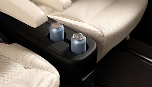 Interior shot of two cans of water in between the luxury seats of a Blacklane Business Van vehicle.