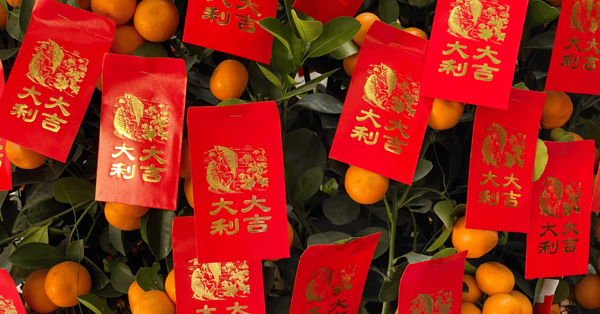 <figcaption class="wp-element-caption">The usual gifts are a pair of Mandarin oranges and a red packet that contains an even amount of money. <em>Image credit: Yuwei Shaw/Unsplash</em></figcaption>