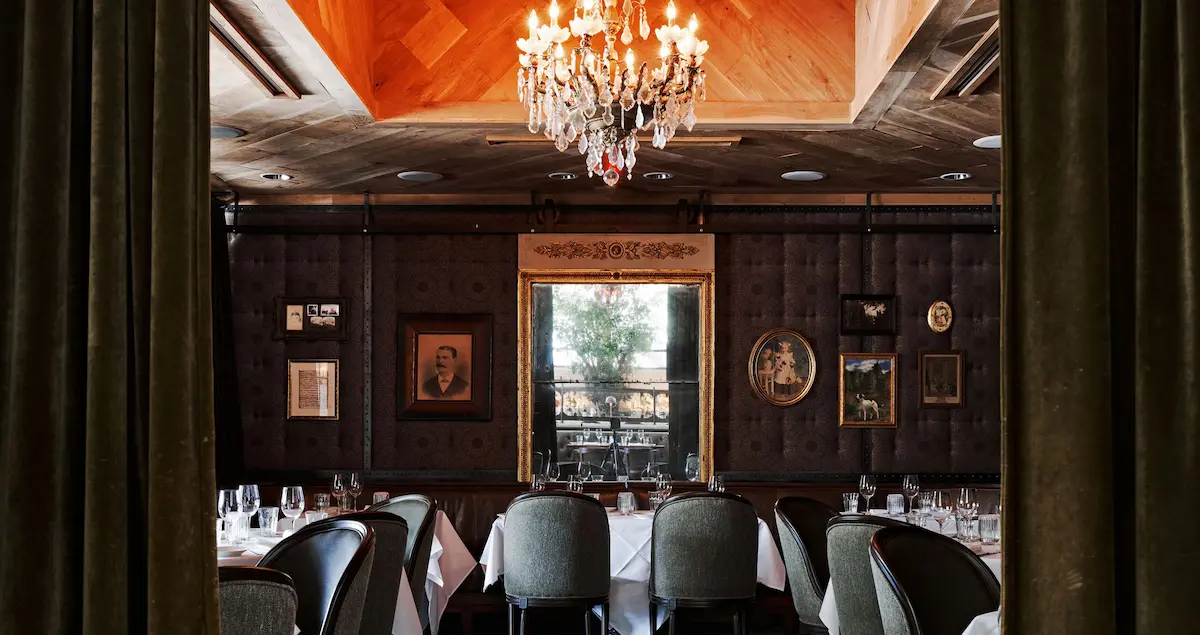 The private dining room at State of Grace restaurant in Houston, showing the dining room and a crystal chandelier.