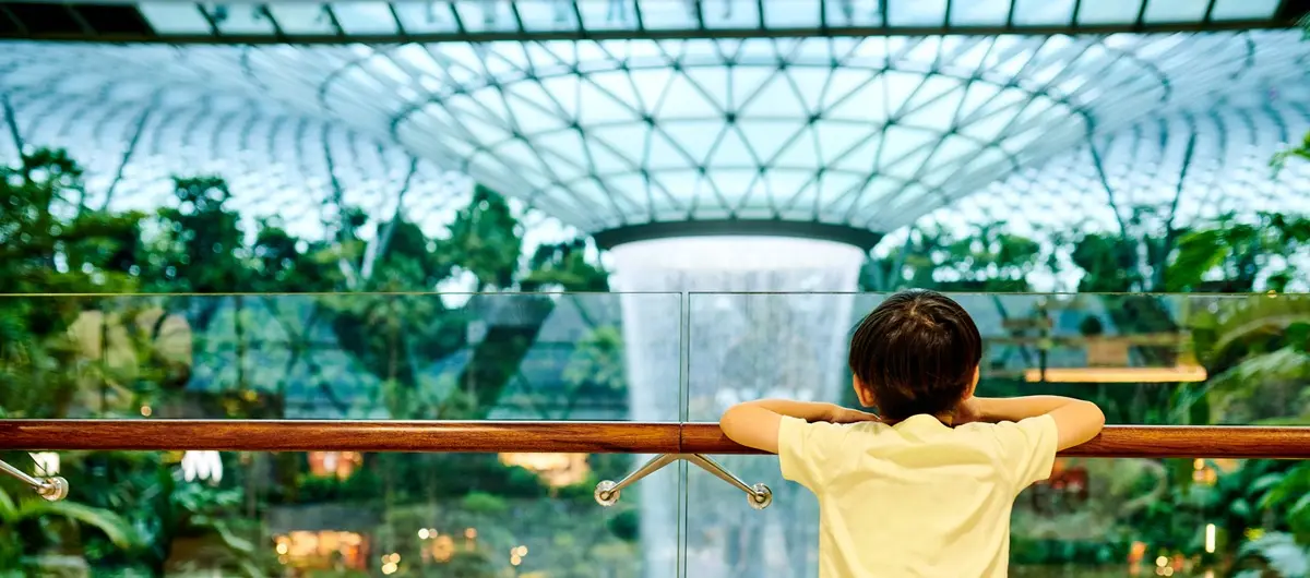 A child looks on at the HSBC Rain Vortex in Singapore's Changi Airport from a walkway.