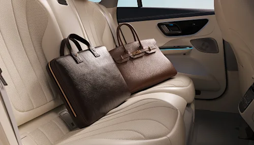 Two luxury leather bags in the backseat of a Blacklane Business Class Car.
