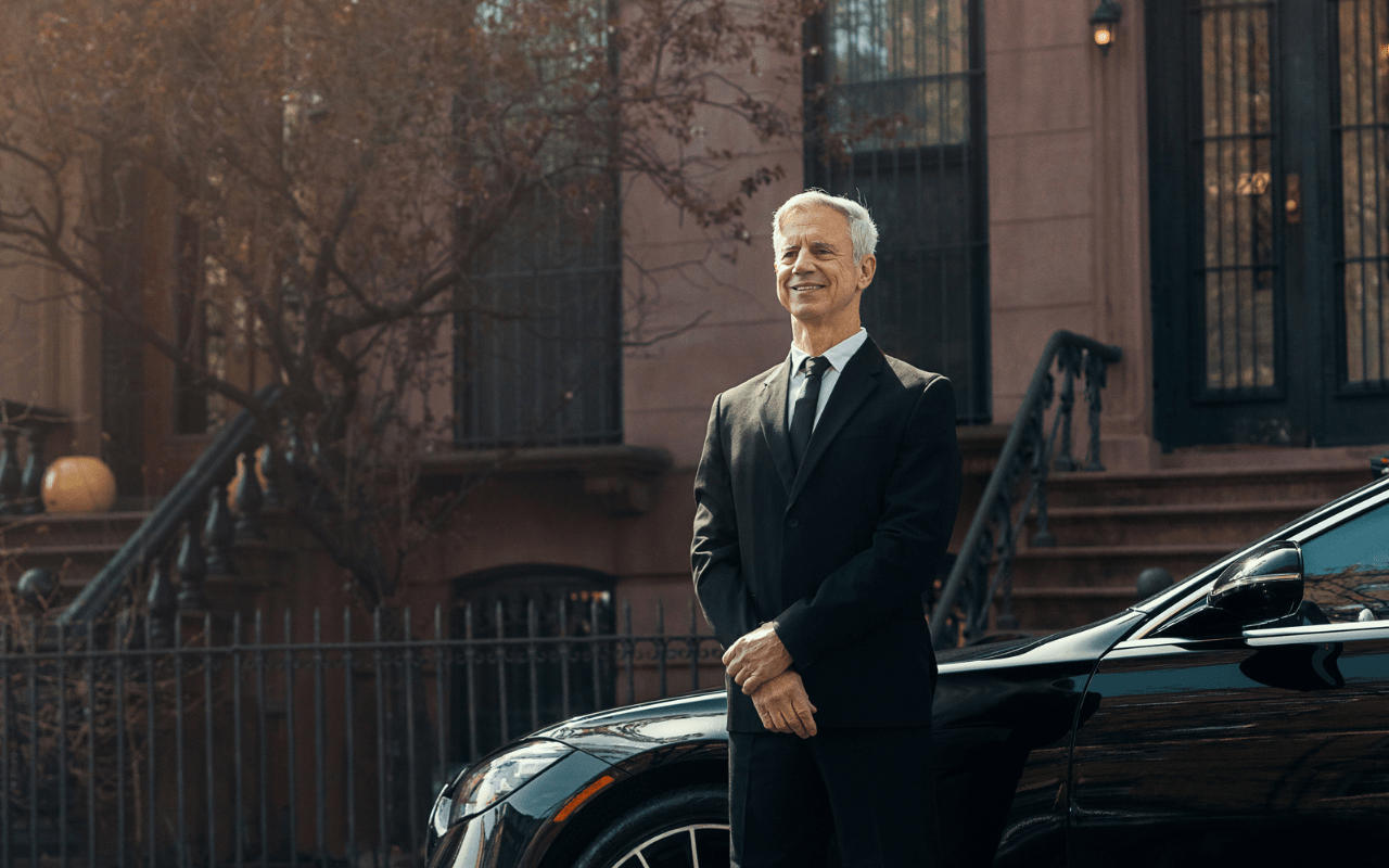 B2B Medium - Chauffeur Standing Next to Vehicle
