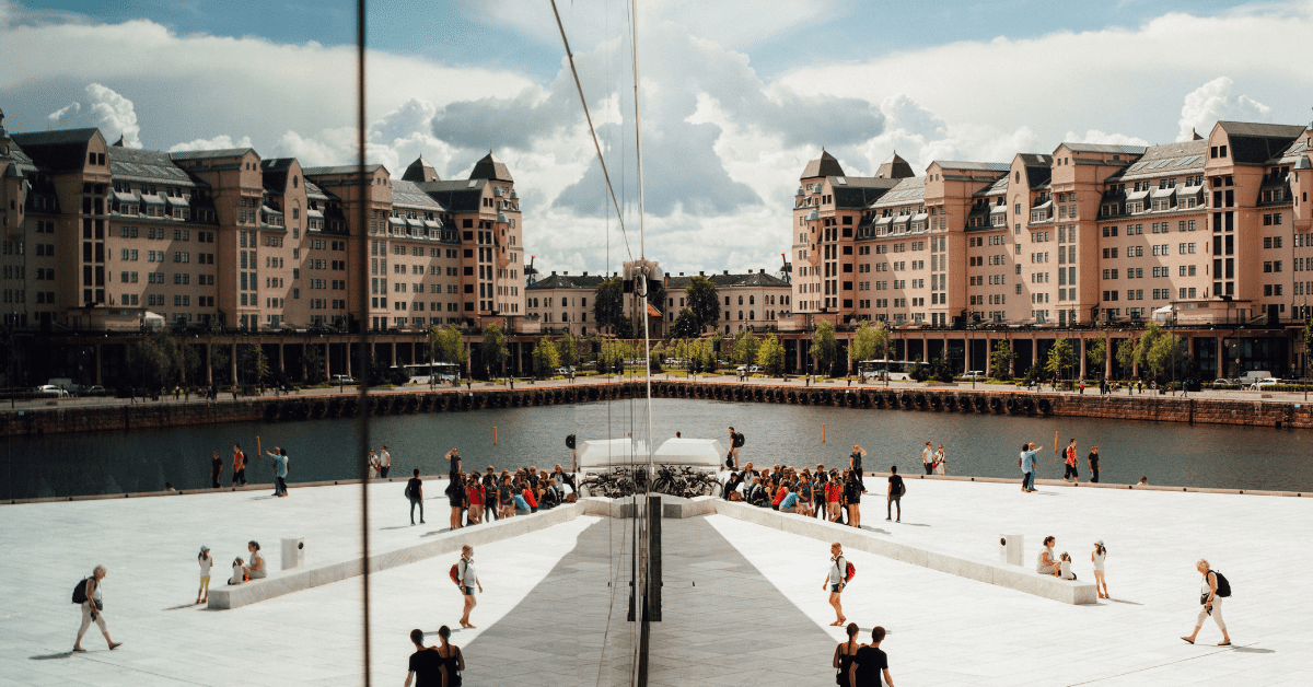 <figcaption class="wp-element-caption">Reflections on Oslo Opera House in Norway. <em>Image credit: Oliver Cole/Unsplash </em></figcaption>