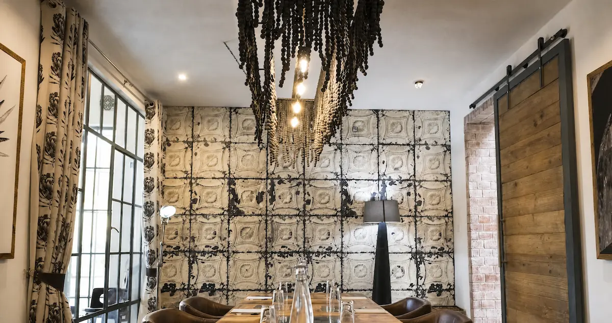 A private dining room table set with a chandelier and a sliding door on the right.
