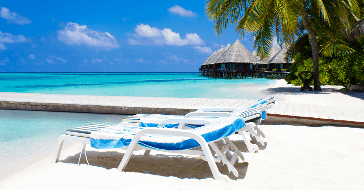 <figcaption>Lounge in a deckchair at Randheli Noonu Atoll.<em> Image credit: AtanasBozhikovNasko/iStock</em></figcaption>