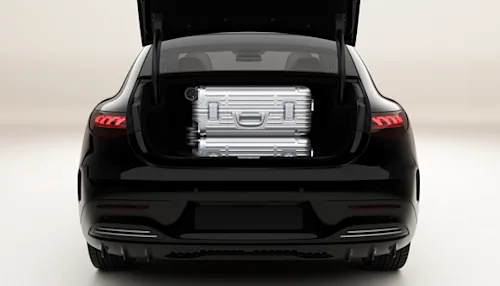 Two standard luggage cases in the open trunk of a Mercedes EQE Blacklane limo.