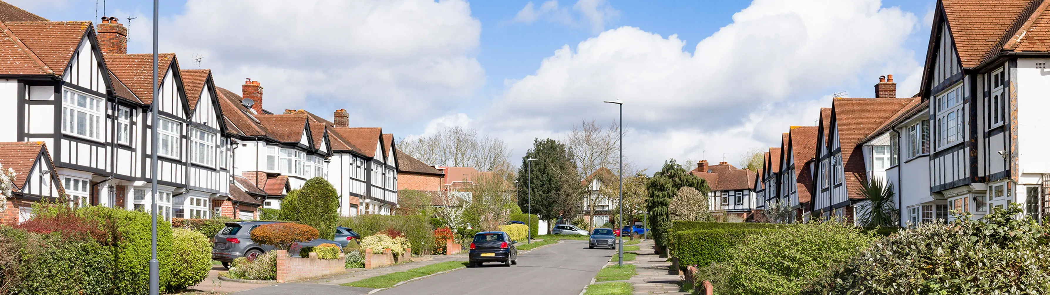 A street of half-timbered houses in suburban London.