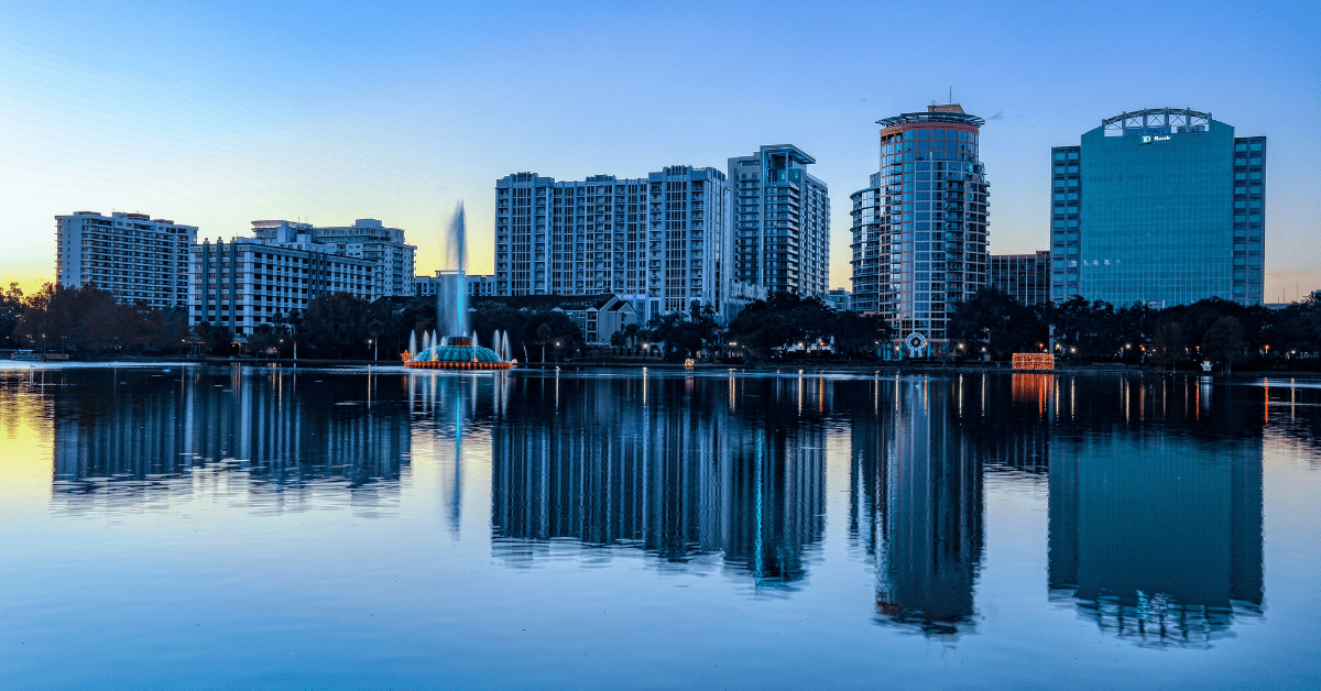 <figcaption>A view of the Orlando skyline over Lake Eola park. <em>Image credit: Mick Haupt/Unsplash</em></figcaption>