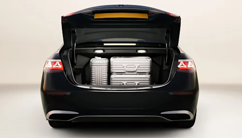 The trunk of a Mercedes Blacklane First Class limo, filled with suitcases.