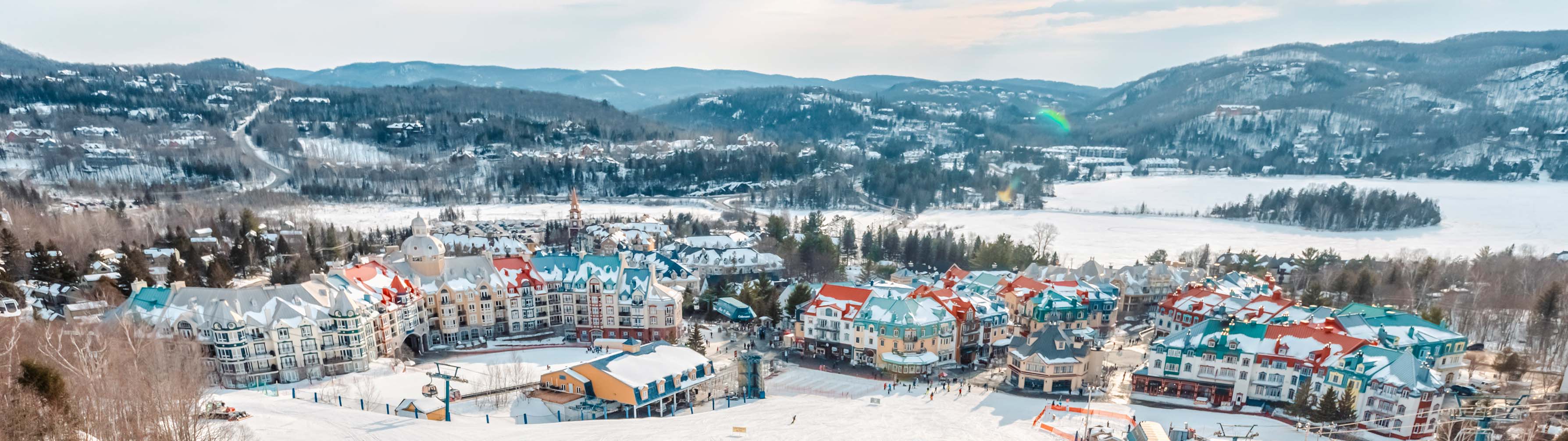 The colorful chalets of Mont Tremblant sit in snow-filled valleys.