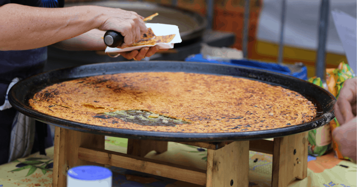 <figcaption>Socca being served on the streets of Nice. Image credit: SabinaS/iStock</figcaption>