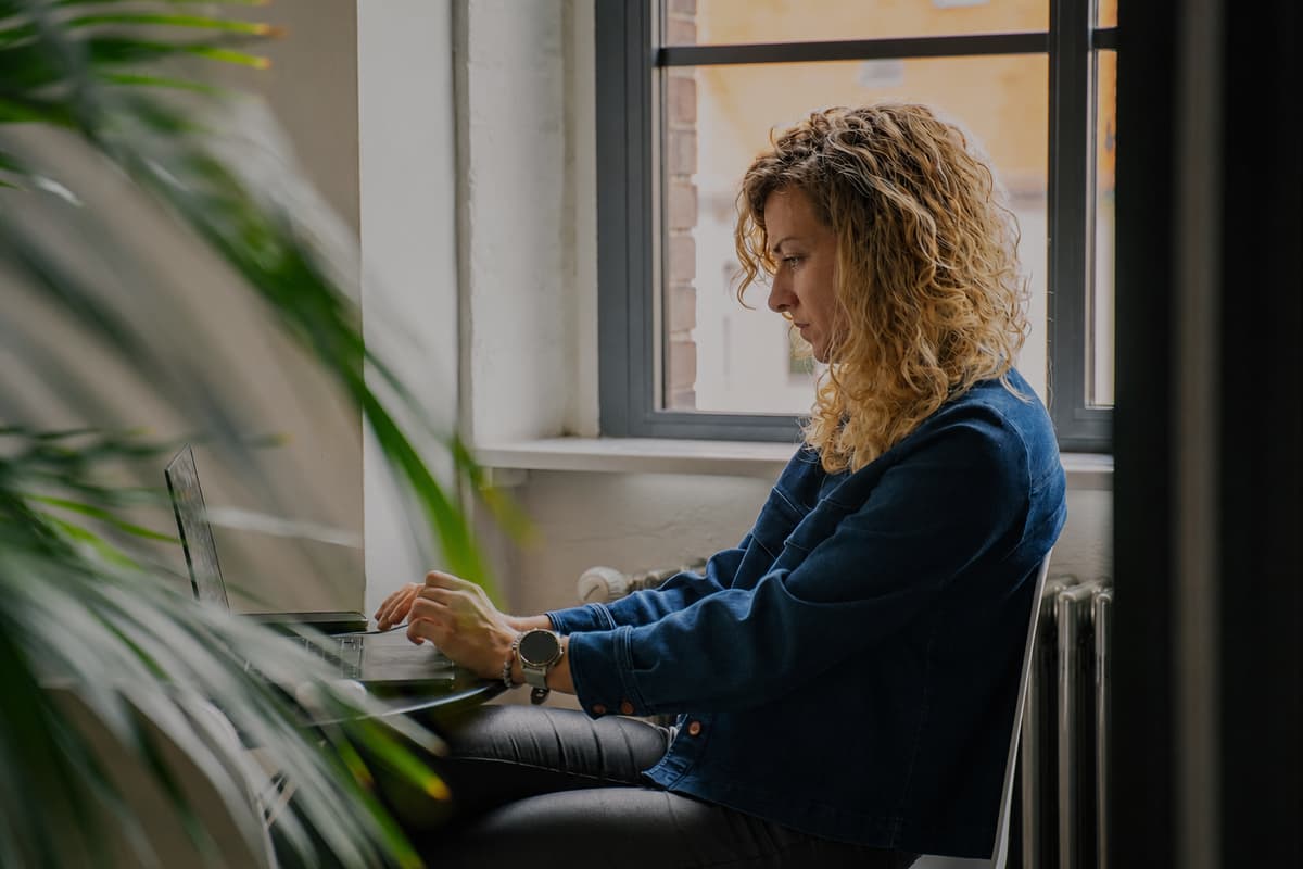 A woman working on a laptop.