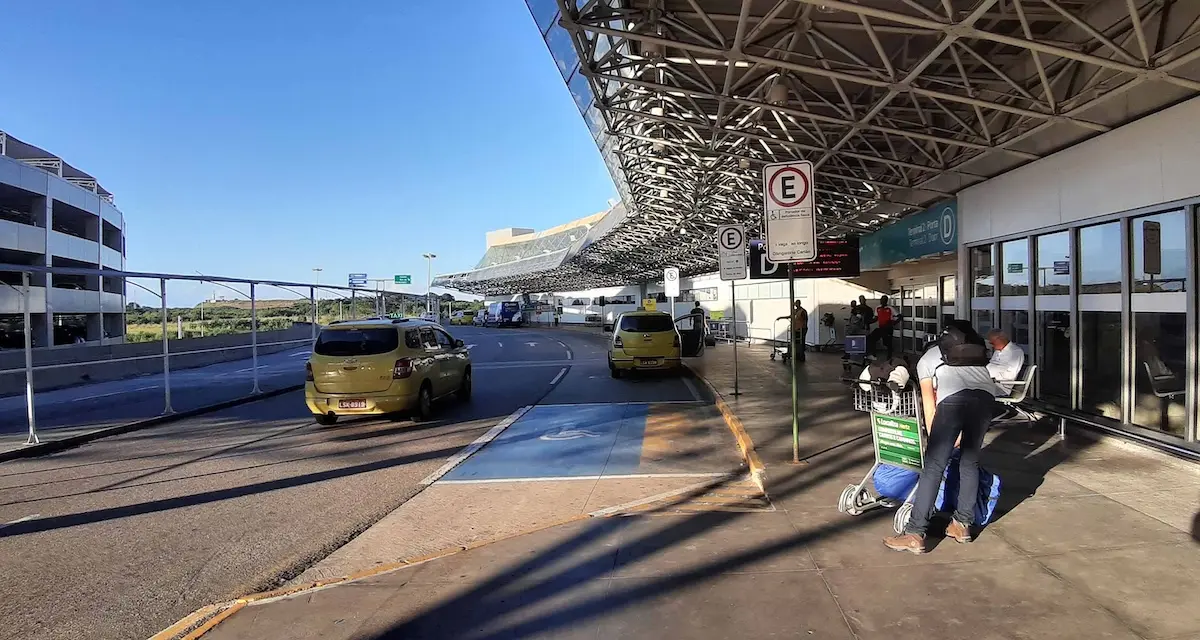 Scene Of People standing at the Taxi Stand At Galeao International Airport Terminal 2 Rio De Janeiro Brazil.