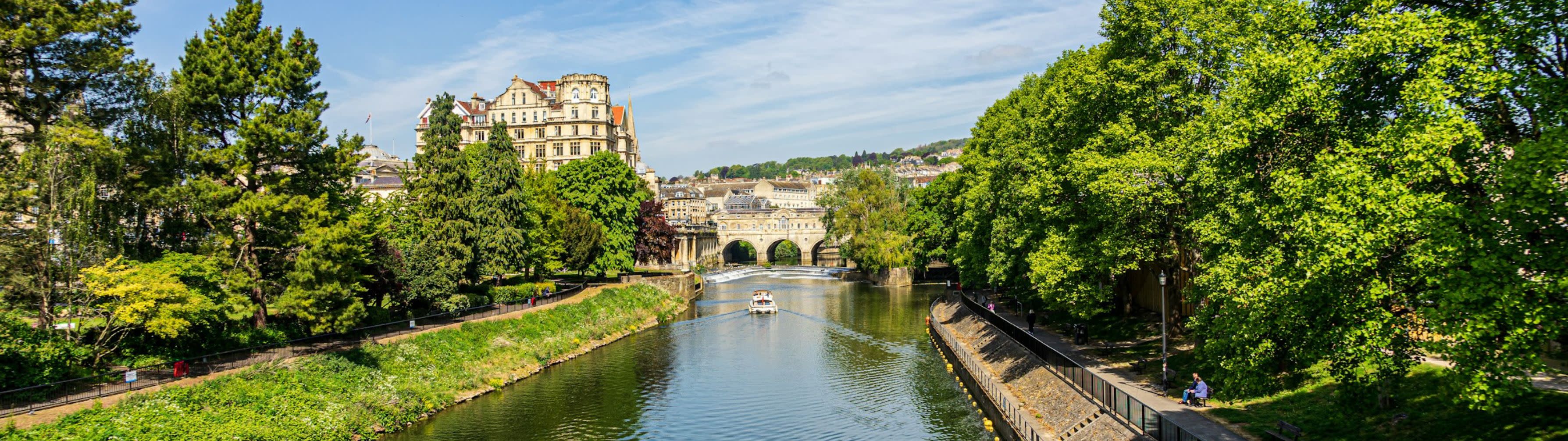 A beautiful waterway and historic bridge in the beautiful English city of Bath.