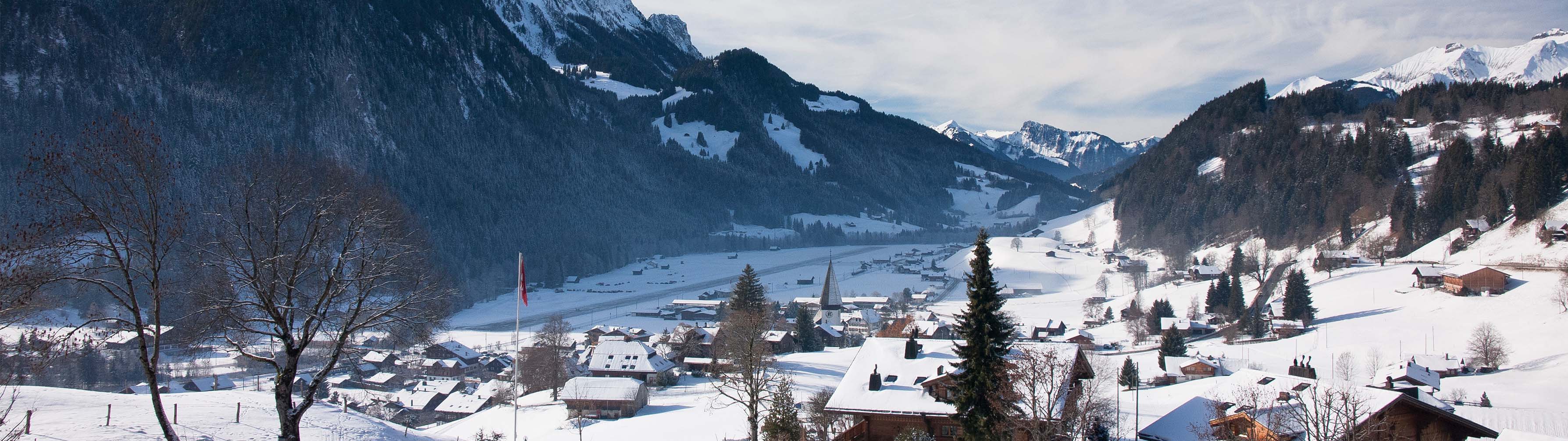 The white valley ans mountain slopes of beautiful Gstaad.