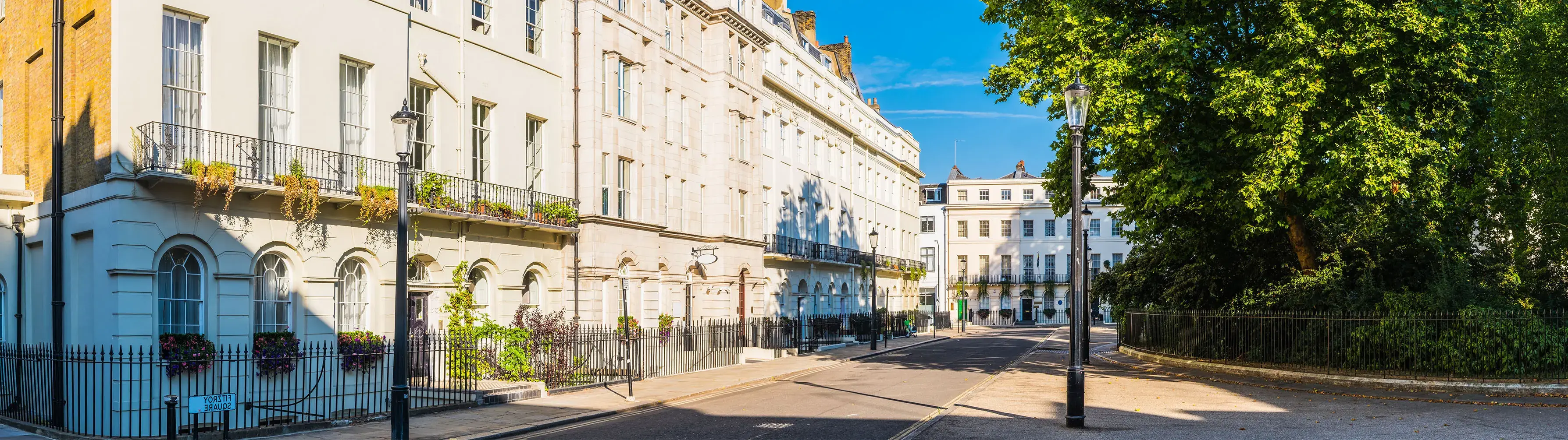 A sunlit terraced street in London's Fitzrovia.