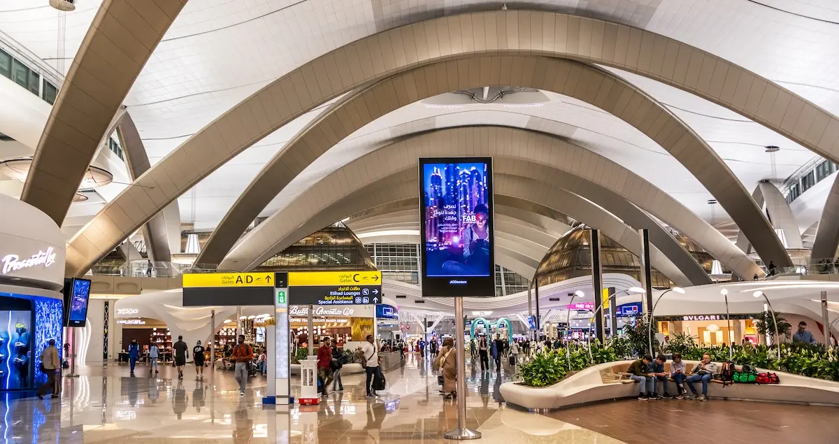 Interior of Zayed International Airport in Abu Dhabi, UAE, showing a shopping concourse and the soaring ceiling.
