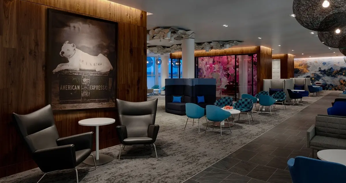 Interior shot of the empty Centurion Lounge at Charlotte Airport, showing relaxed, stylish seating and soft lighting.