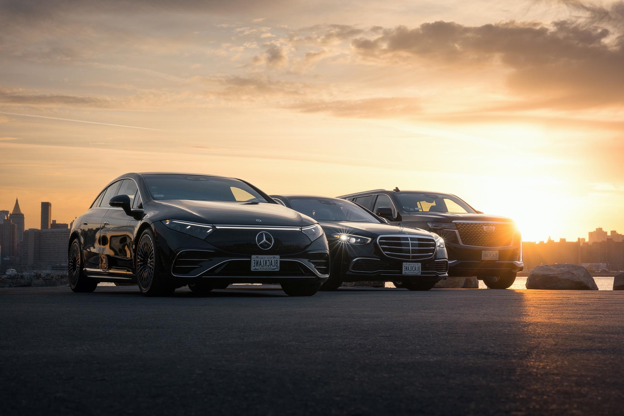 B4B - Cars Tesla and Mercedes sedan and van next to each other at sunset