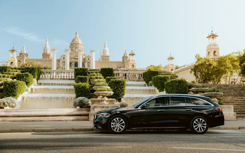 A Mercedes estate car parked outside the Palau Nacional (National Palace) on the hill of Montjuïc in Barcelona, Spain, which serves as the home of the Museu Nacional d'Art de Catalunya (MNAC).