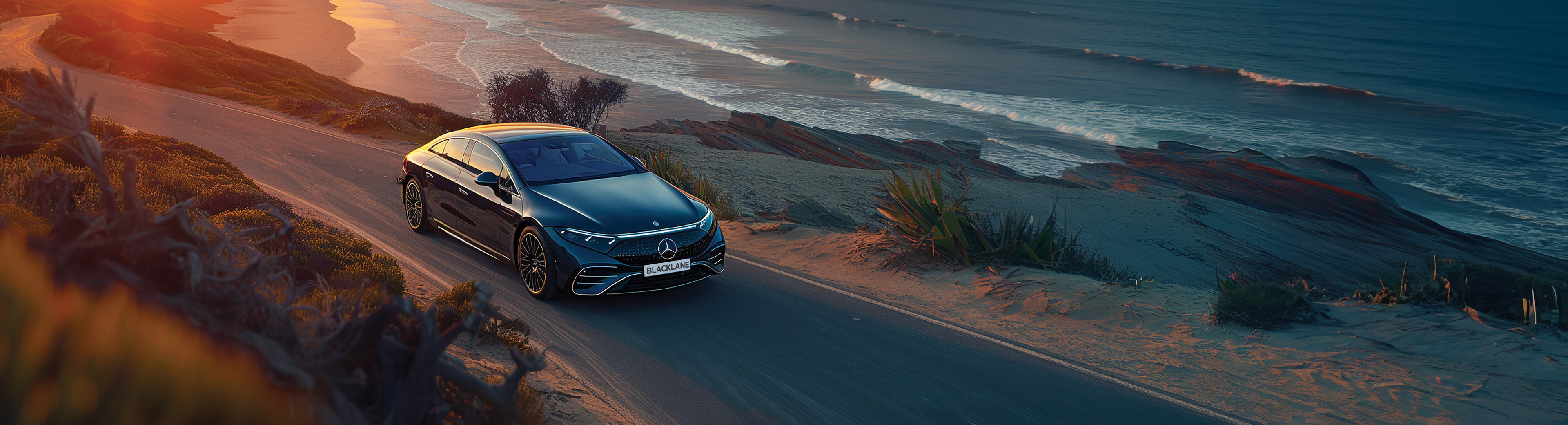 Black Mercedes with a Blacklane license plate driving on a road near a beach.