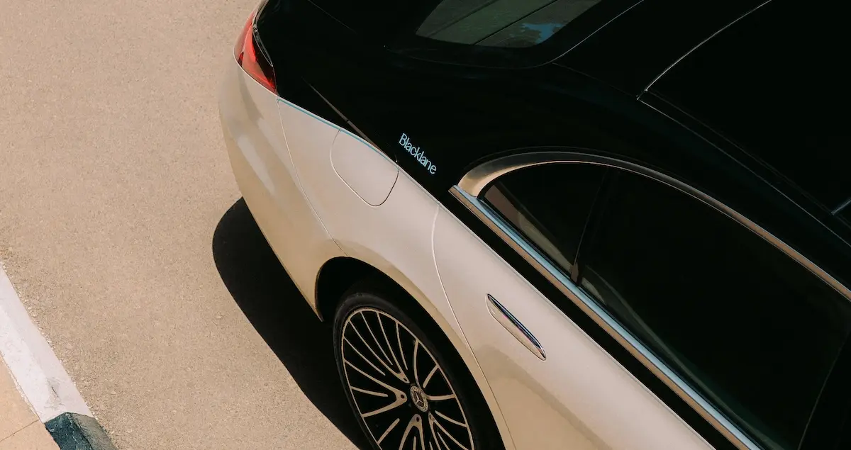 Close-up shot from above of the back end of a two-tone Mercedes EQS by global chauffeur brand Blacklane.