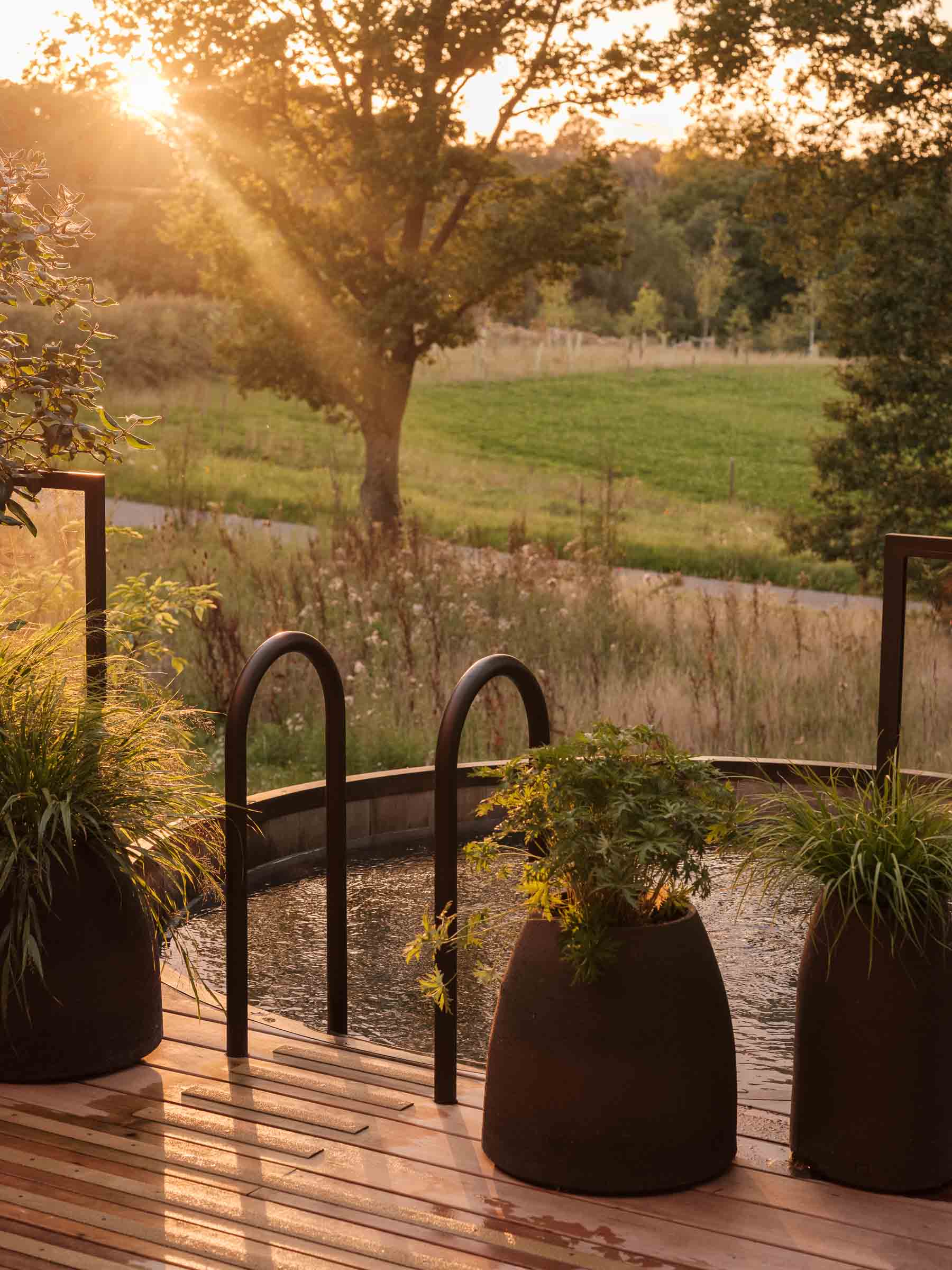 A view of the plunge pool in the Heckfield House spa hotel outside London at sunset.