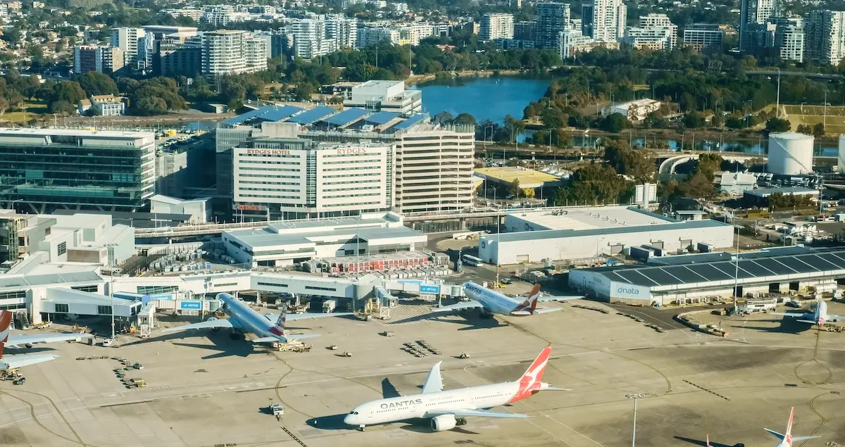 Aerial view of a Qantas plane waiting to waiting to board passengers on a sunny winter morning at Kingsford Smith International Airport.