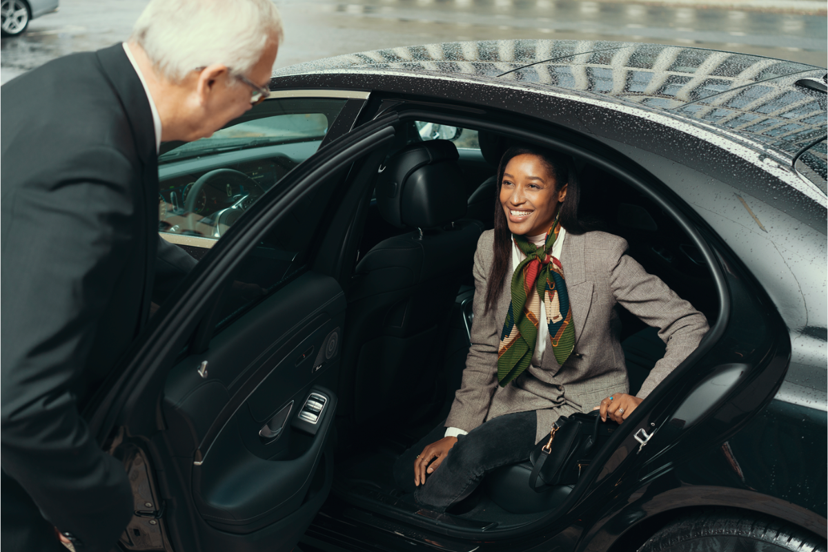 1280 px 800 px Woman getting out of car with chauffeur B4B