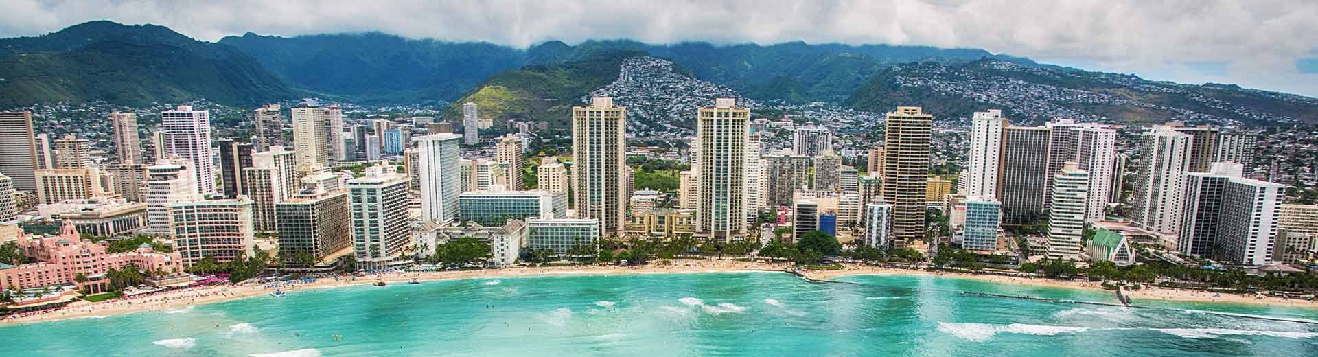 The tall hotels of Waikiki look over the turqoise waters and pristine, white beaches.
