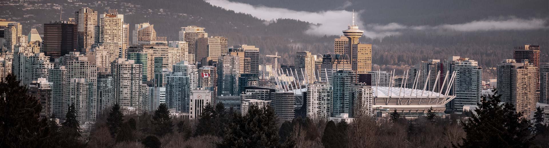 在温哥华寒冷的一天，著名的温哥华观景台（Vancouver Lookout）从高楼大厦的后面探出头来。