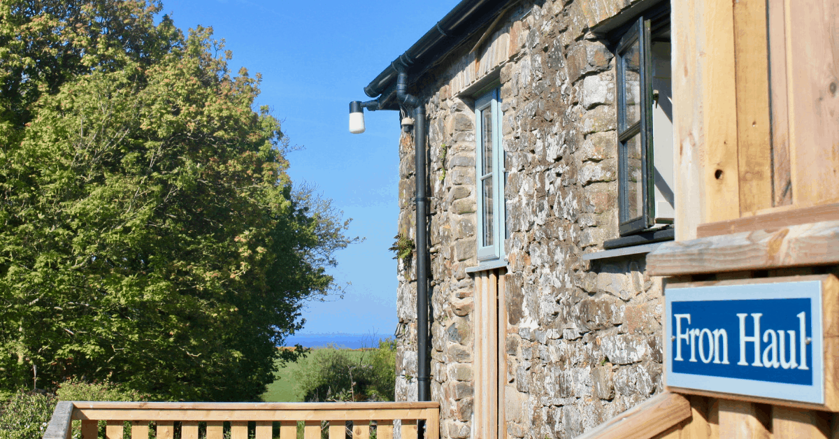 <figcaption>The front porch view at Fron Haul. <em>Image credit: Premier Cottages</em></figcaption>