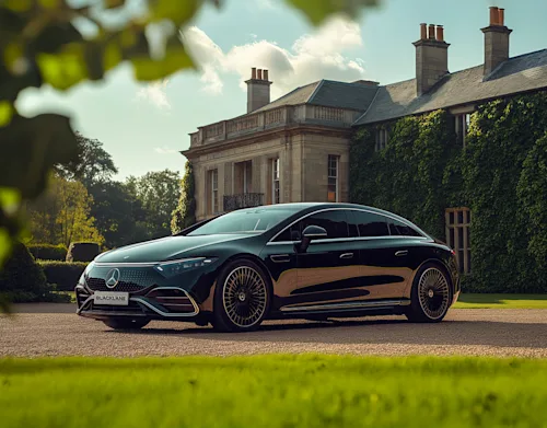 Shot of a Blacklane Mercedes EQS limousine outside a stately manor home.