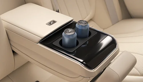 Two cans of water in the backseat of a Blacklane Business Class vehicle.